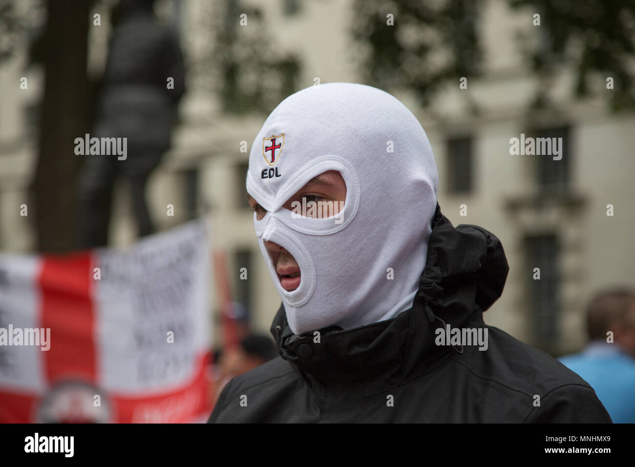 A member of the EDL wearing a white balaclava with the word EDL printed on it Stock Photo