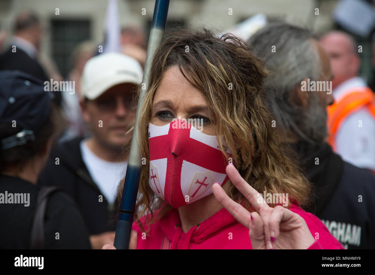 A female member of the EDL wearing a St Georges flag face mask Stock Photo
