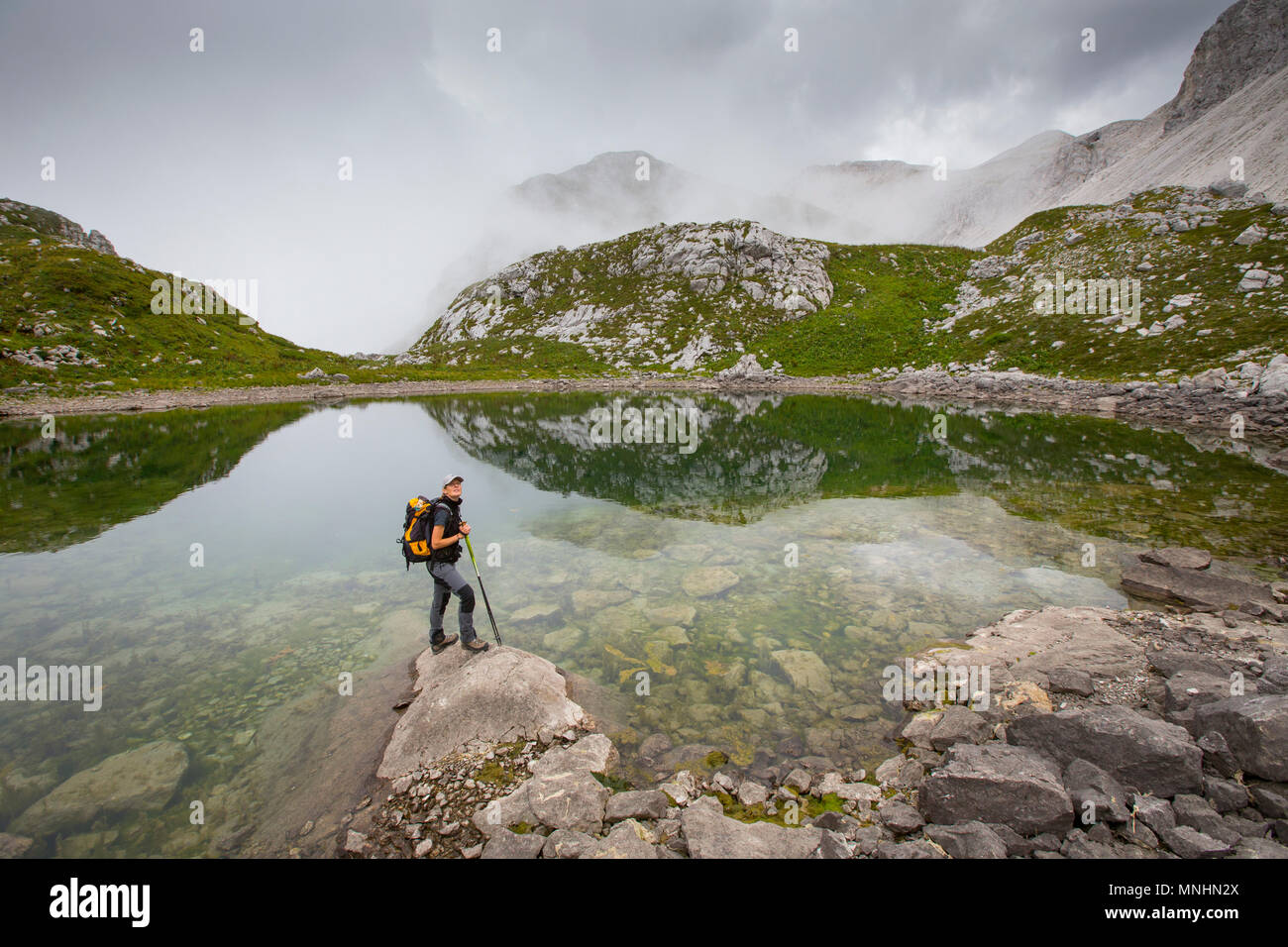 Ranger of Triglav National Park at lake near Krn mountain, Julian Alps, Slovenia Stock Photo