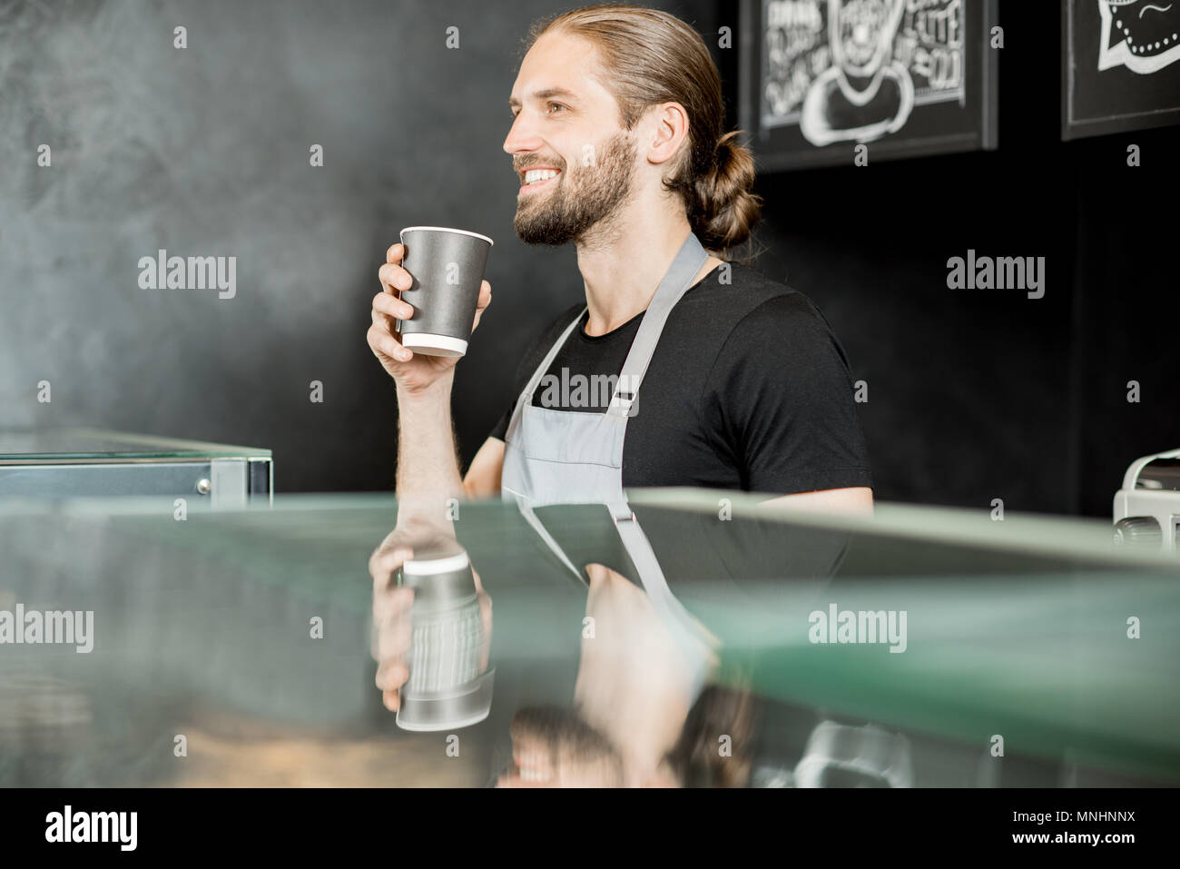 Handsome barista in uniform hi-res stock photography and images - Alamy