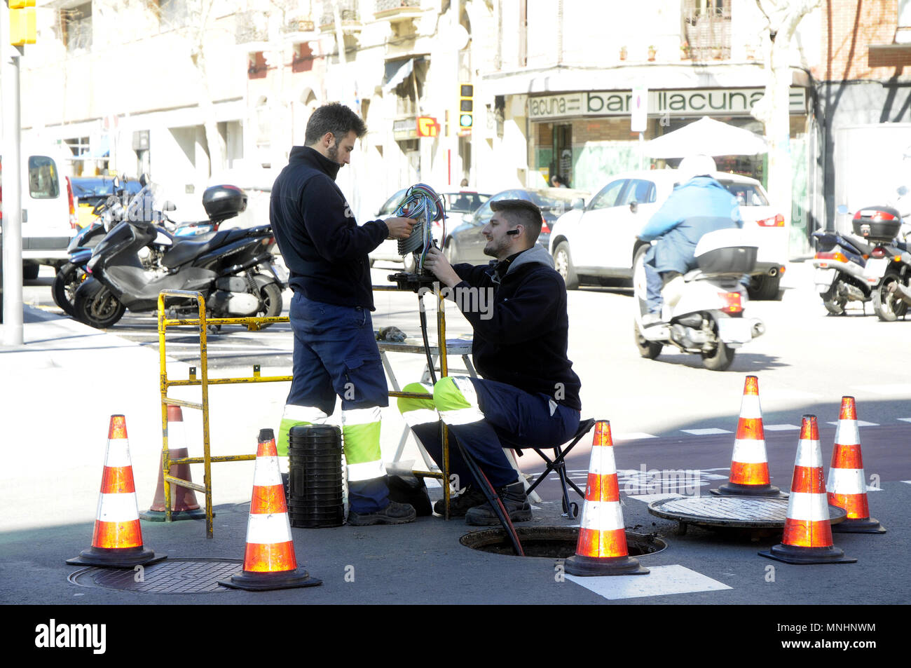 TECHNICIANS INSTALLING OPTIC FIBER Stock Photo
