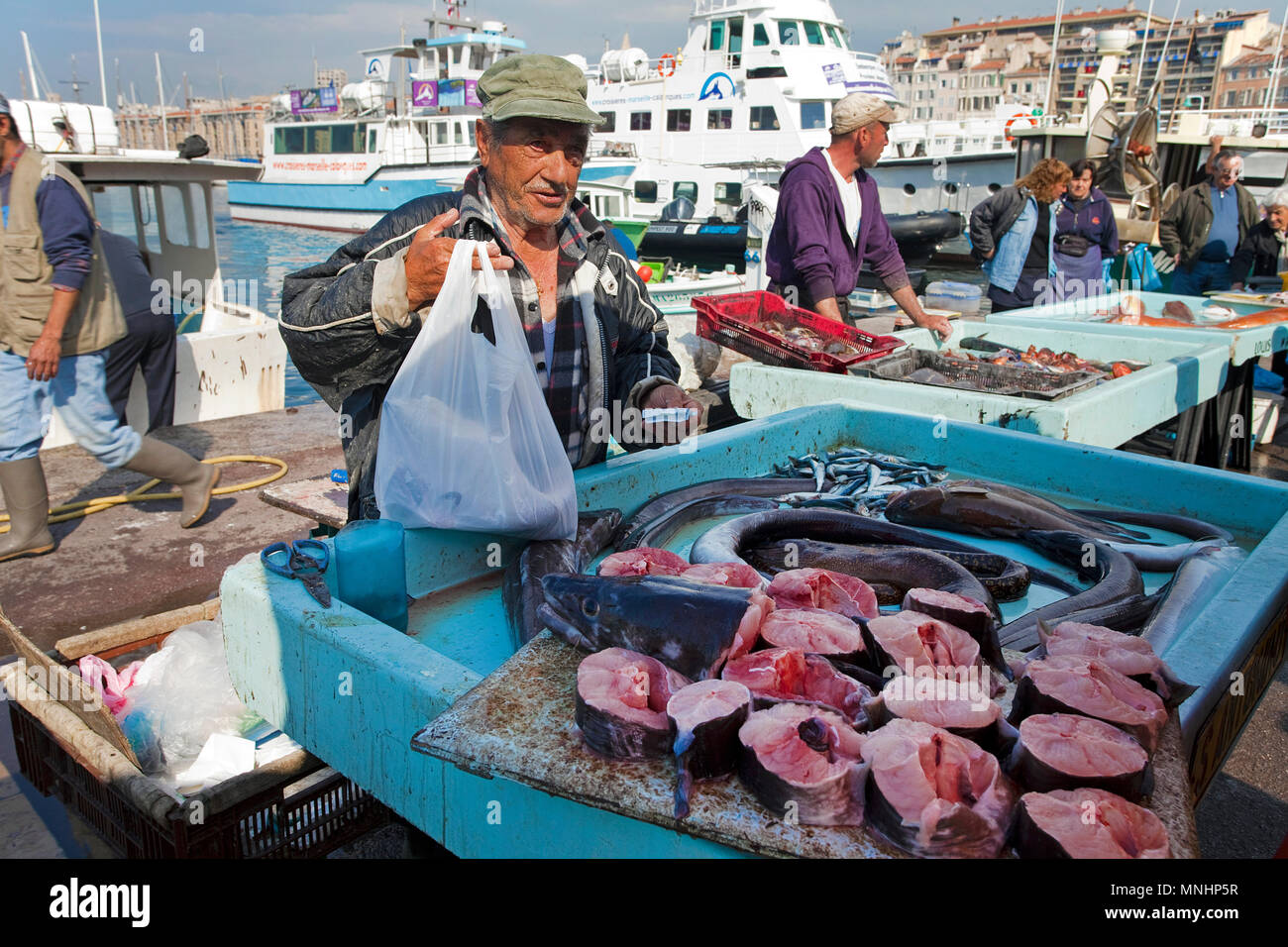 Fisherman selling fish at harbour Vieux Port, Marseille, Bouches-du-Rhone, Provence-Alpes-Côte d’Azur, South France, France, Europe Stock Photo