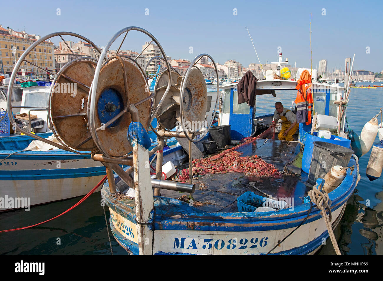 Fisherman at harbour Vieux Port, Marseille, Bouches-du-Rhone, Provence-Alpes-Côte d’Azur, South France, France, Europe Stock Photo