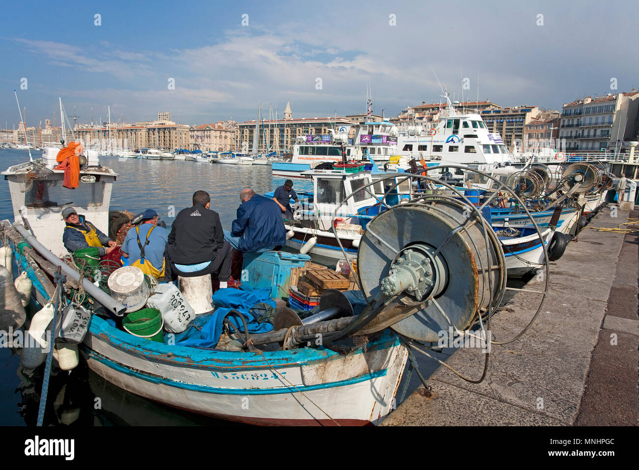 Fisherman at harbour Vieux Port, Marseille, Bouches-du-Rhone, Provence-Alpes-Côte d’Azur, South France, France, Europe Stock Photo