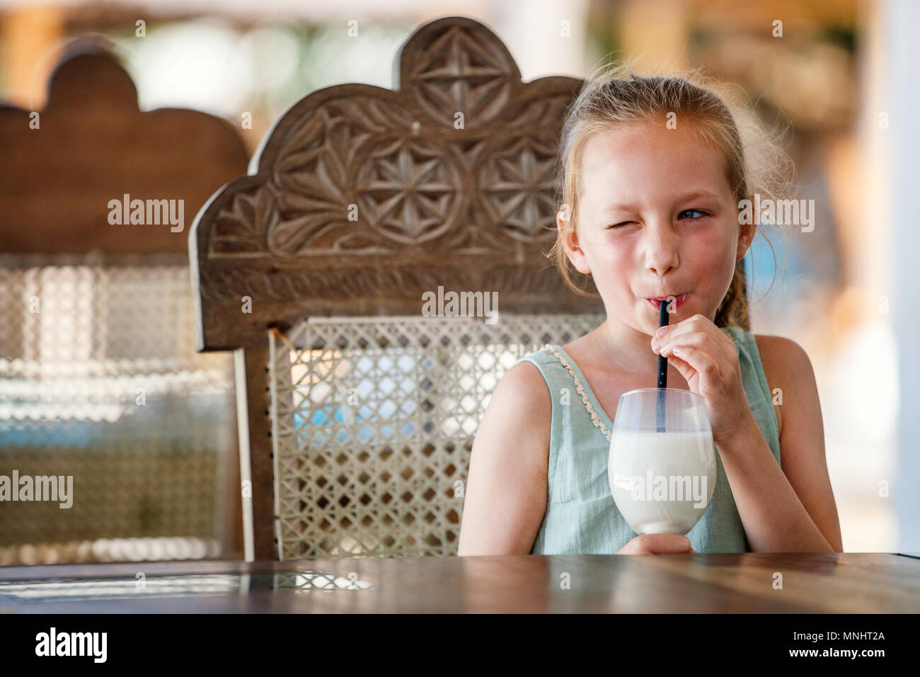 Portrait of adorable little girl drinking milkshake Stock Photo