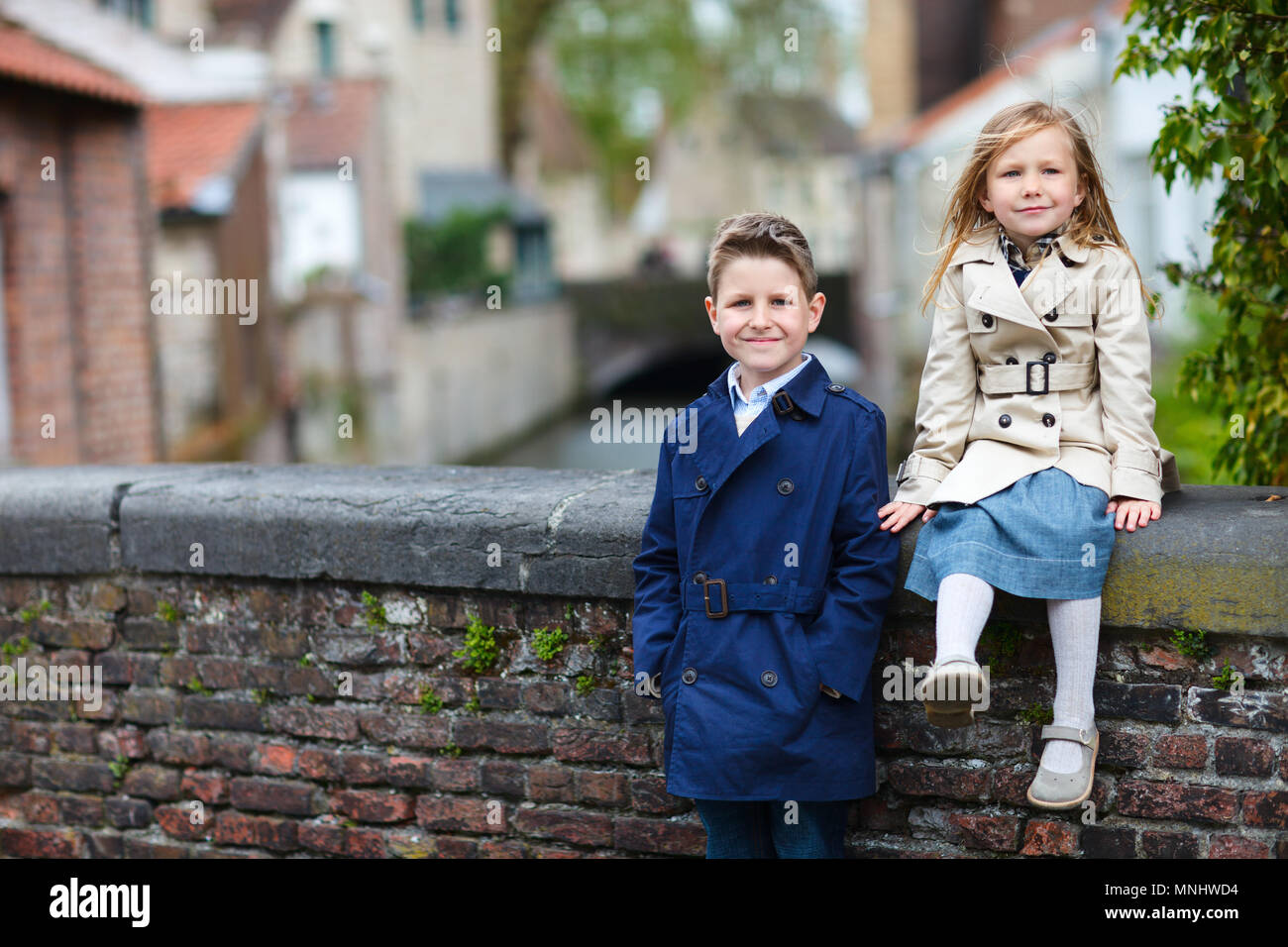 Brother and sister outdoors in city on beautiful spring day Stock Photo