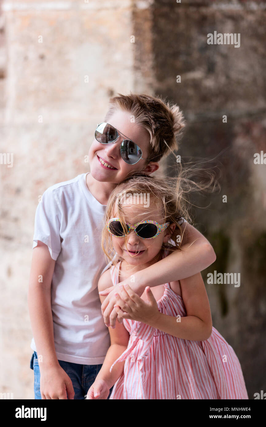 Happy brother and sister outdoors in a city Stock Photo
