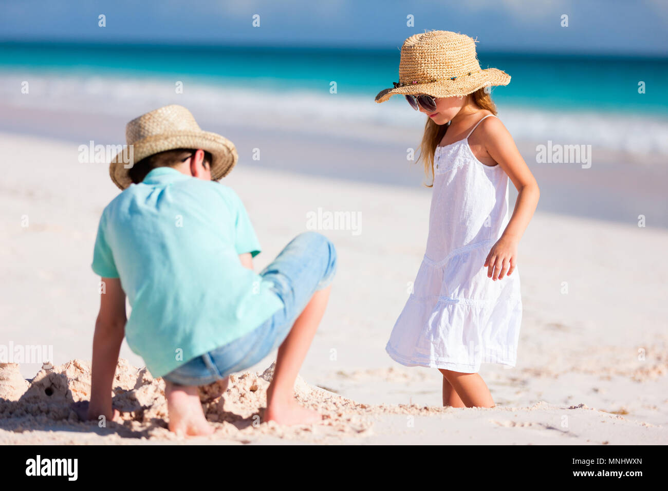 Brother And Sister Having Fun On Beach High Resolution Stock ...