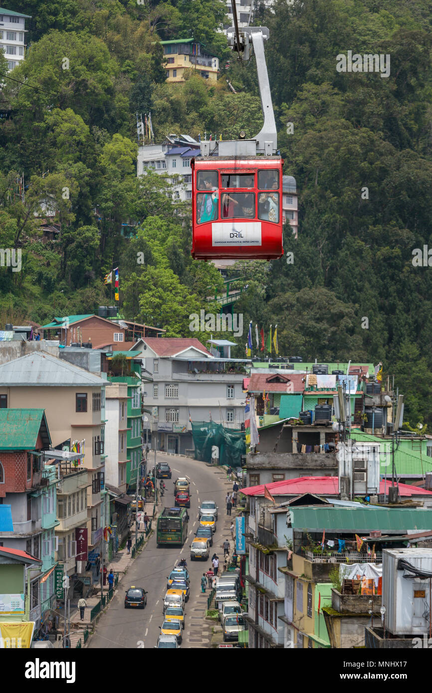 Gangtok, India - May 1, 2017: Tourists enjoy a ropeway cable car in Gangtok city in cloudy day. Stock Photo