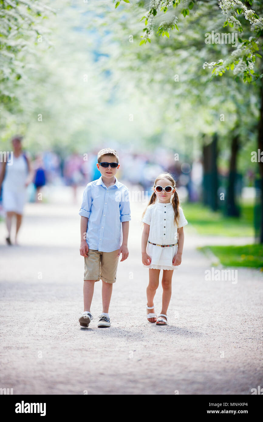 Kids brother and sister outdoors in a beautiful park at spring day ...
