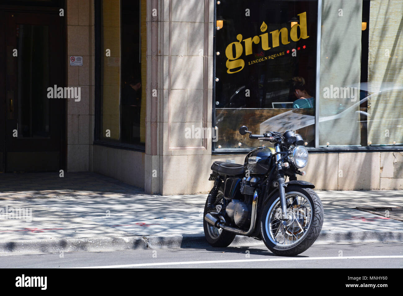 A Black Triumph Motorcycle Parked Outside Of Local Coffee Shop In Chicagos Lincoln Square Neighborhood