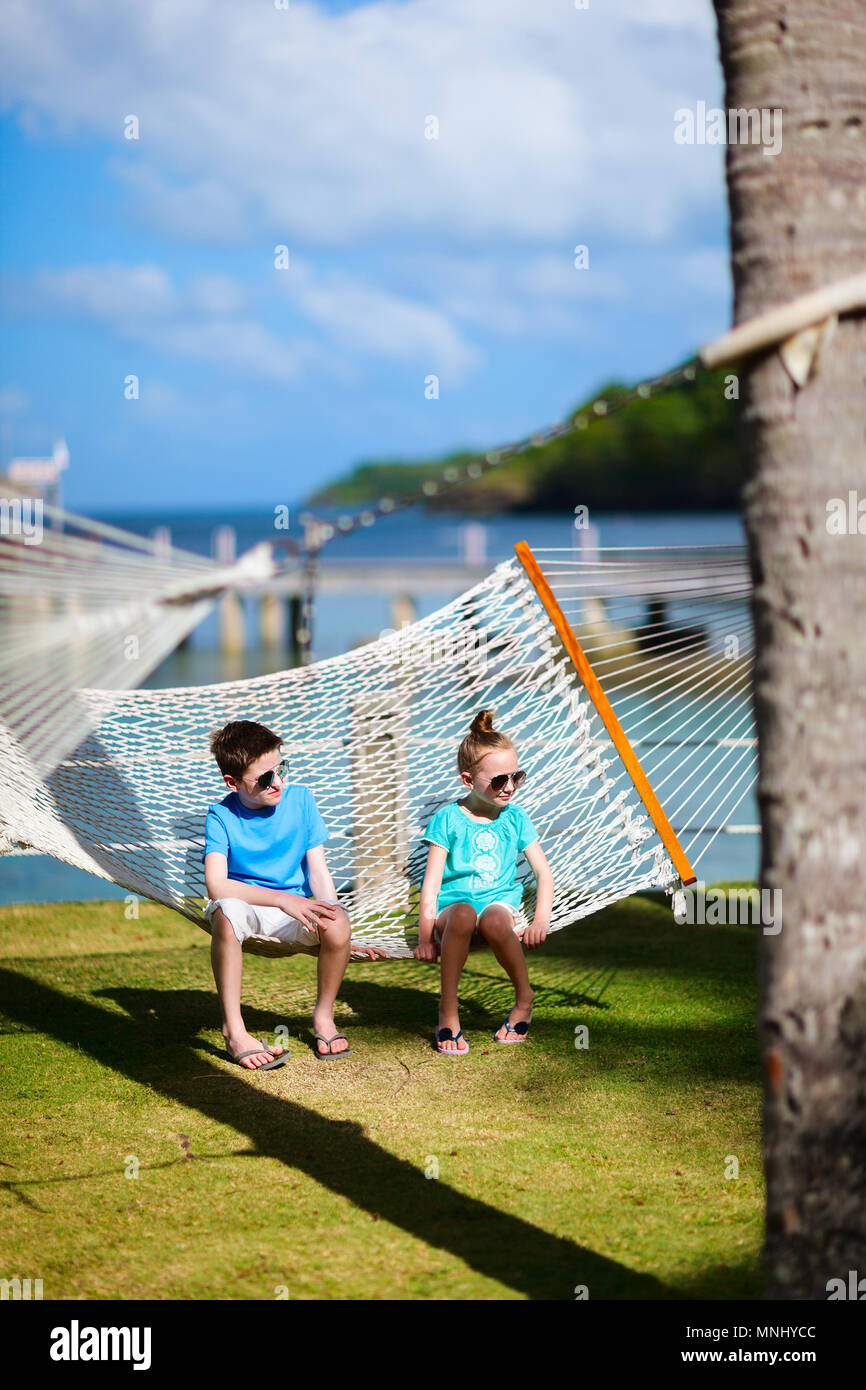 Kids brother and sister relaxing in hammock Stock Photo - Alamy