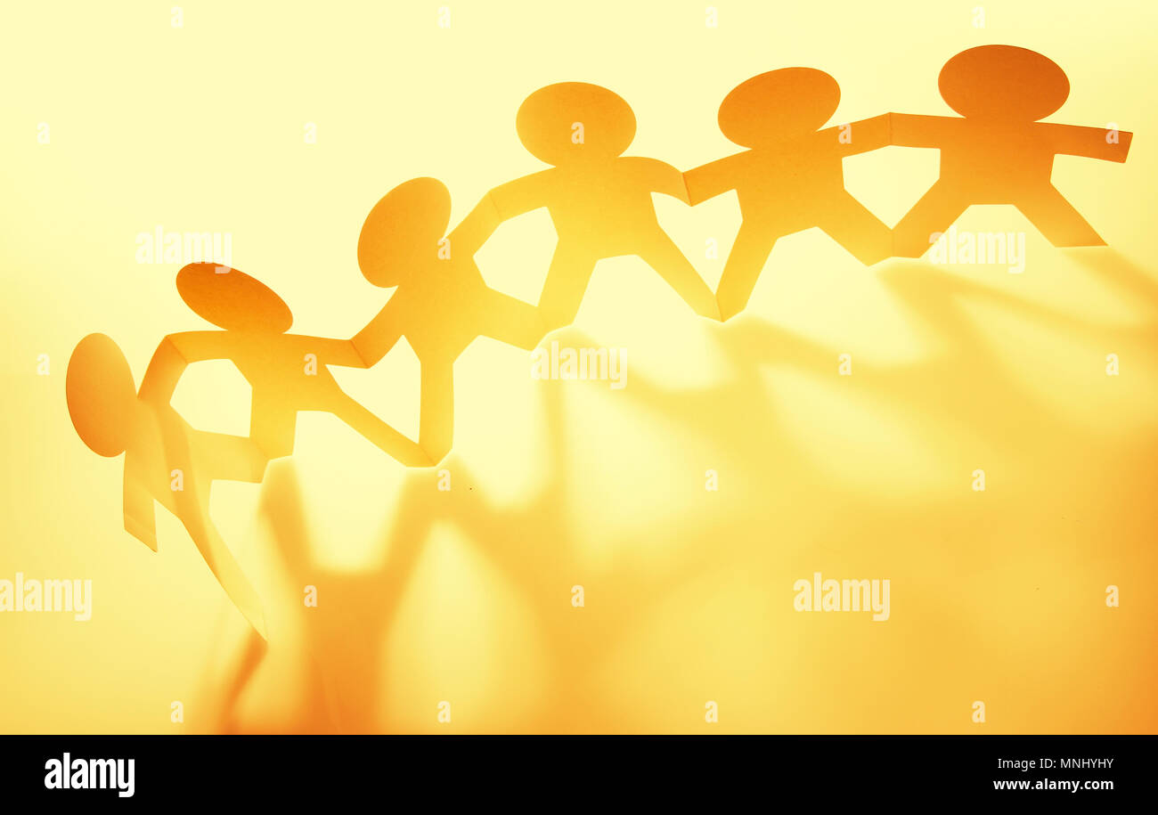 Team of paper chain people in a row holding hands Stock Photo - Alamy