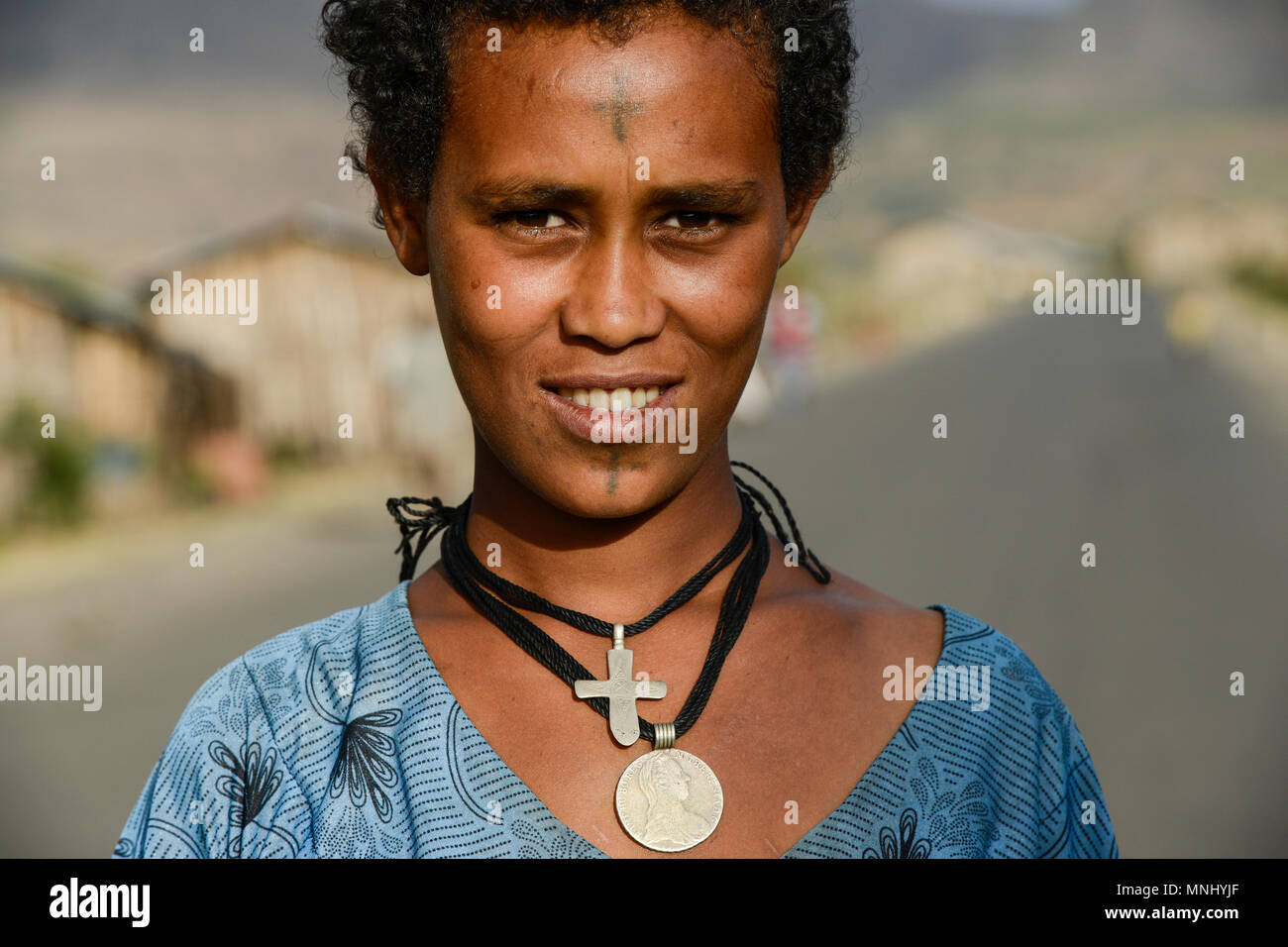 ETHIOPIA, Amhara, village near Gondar, amharic orthodox christian woman with tattooed cross on the forehead and cross necklace / AETHIOPIEN, Amhara, Gonder, orthodoxe Christin mit auf der Stirn taetowiertem Kreuz und Halskette in einem Dorf Stock Photo