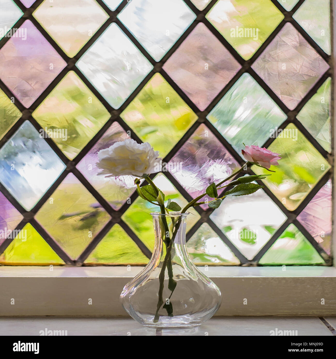 Colorful stained glass with flowers in vase vintage old home Stock