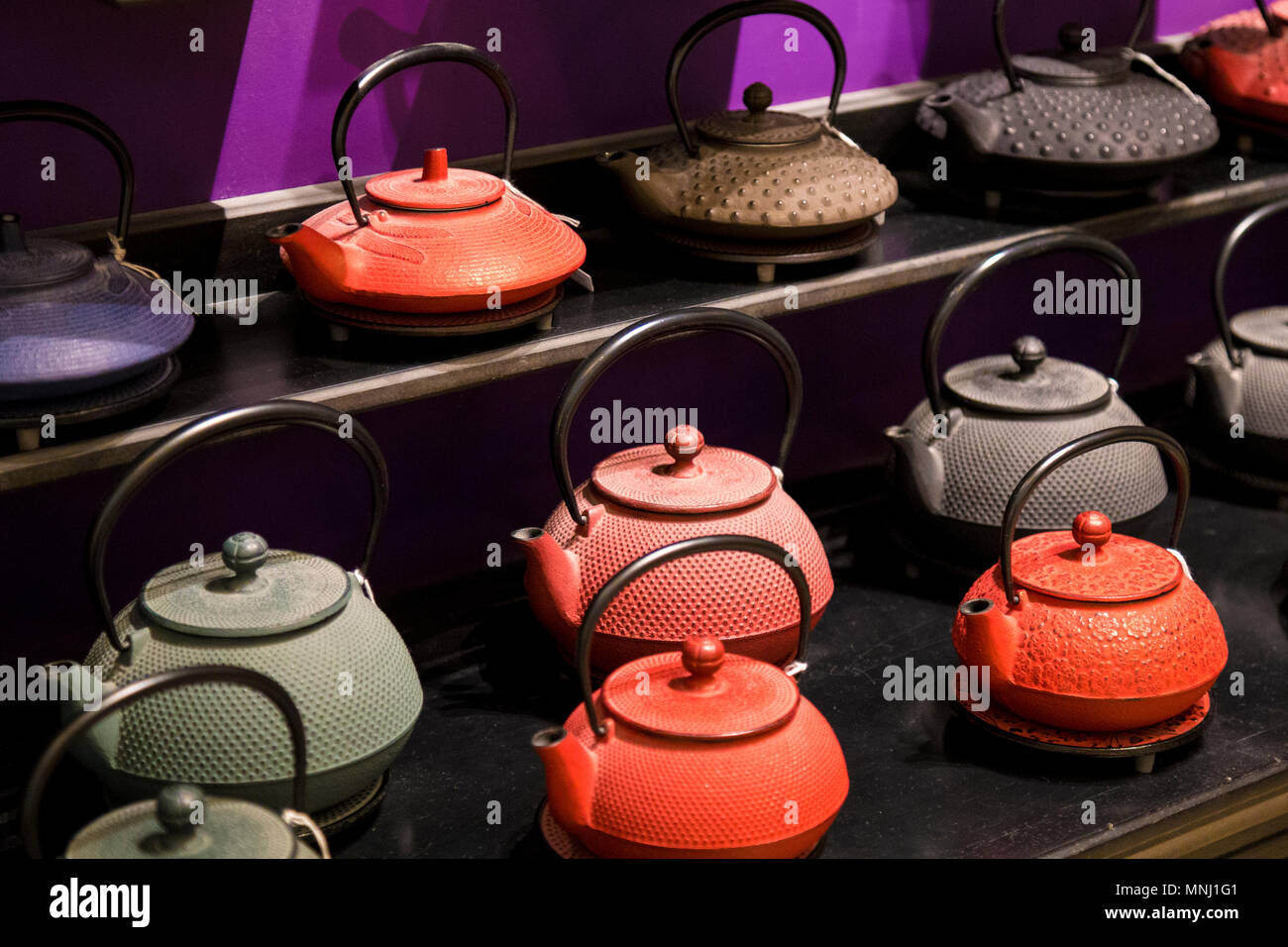 A selection of colourful Japanese cast iron tea pots - tetsubin Stock Photo