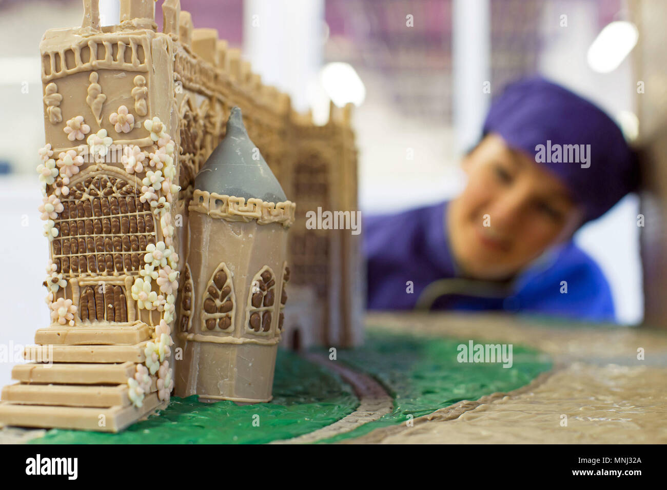 A chocolatier looks at a recreation of St George's Chapel in Windsor at Cadbury World in Birmingham, which is made entirely out of chocolate ahead of the royal wedding this weekend. Stock Photo