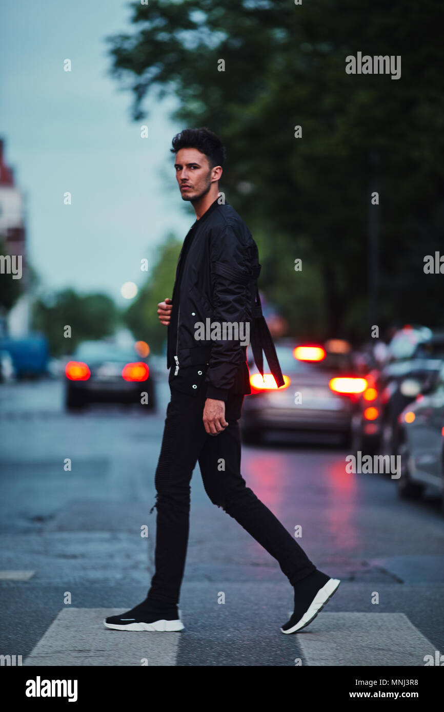 Portrait of stylish man on night city background pose to camera Stock Photo  | Adobe Stock