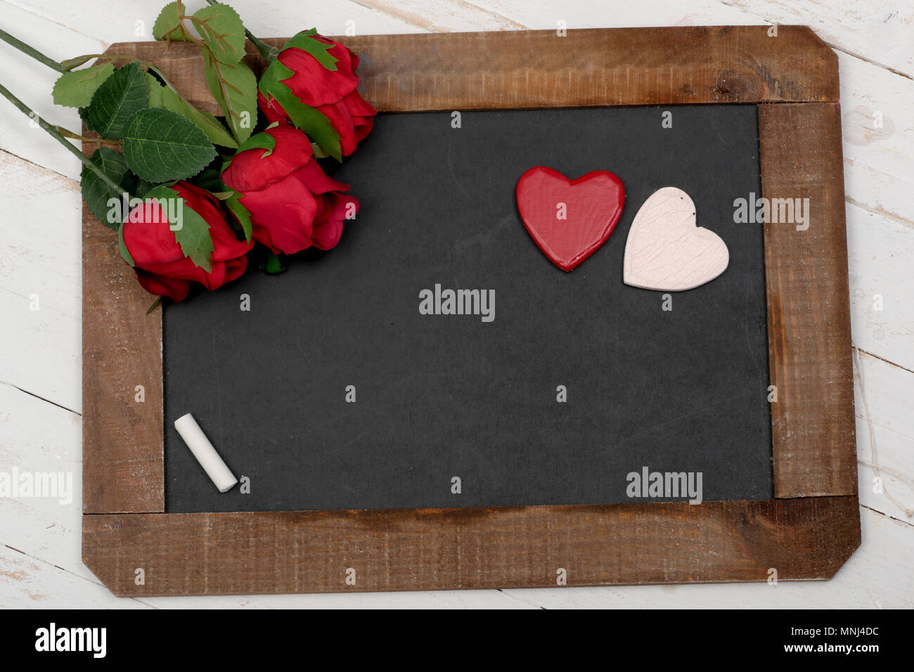 a concept romantic, small chalkboard, roses and heart Stock Photo - Alamy