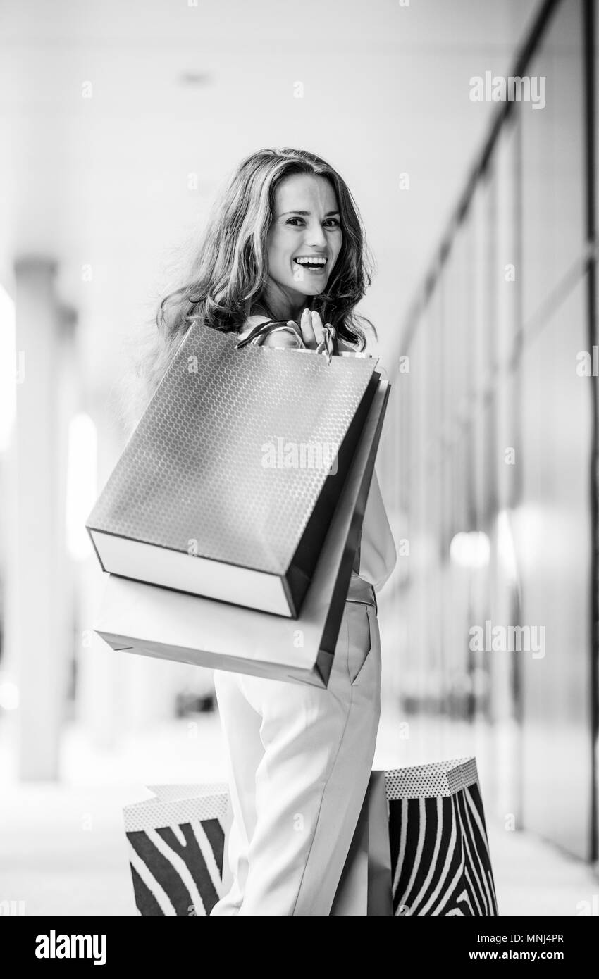 Portrait of happy young woman with shopping bags Stock Photo