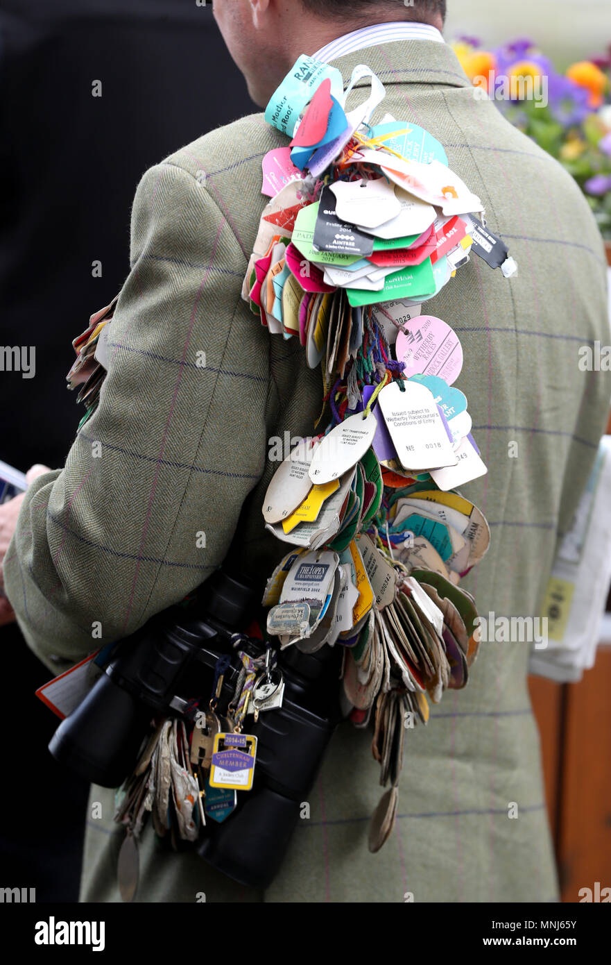A racegoer shows off his previous passes day two of the 2018 Dante Festival at York Racecourse, York. Stock Photo