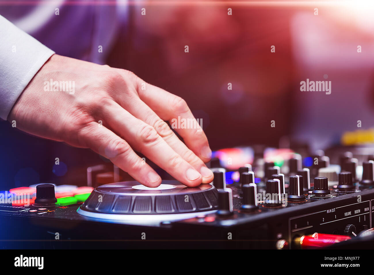 Disk jockey playing music at dj controller Stock Photo Alamy