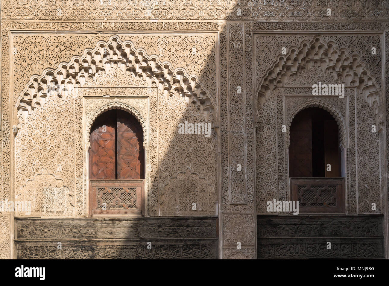 Ornate walls made of stone with traditional details. Islamic school Madrasa Bou Inania in Fez, Morocco. Stock Photo