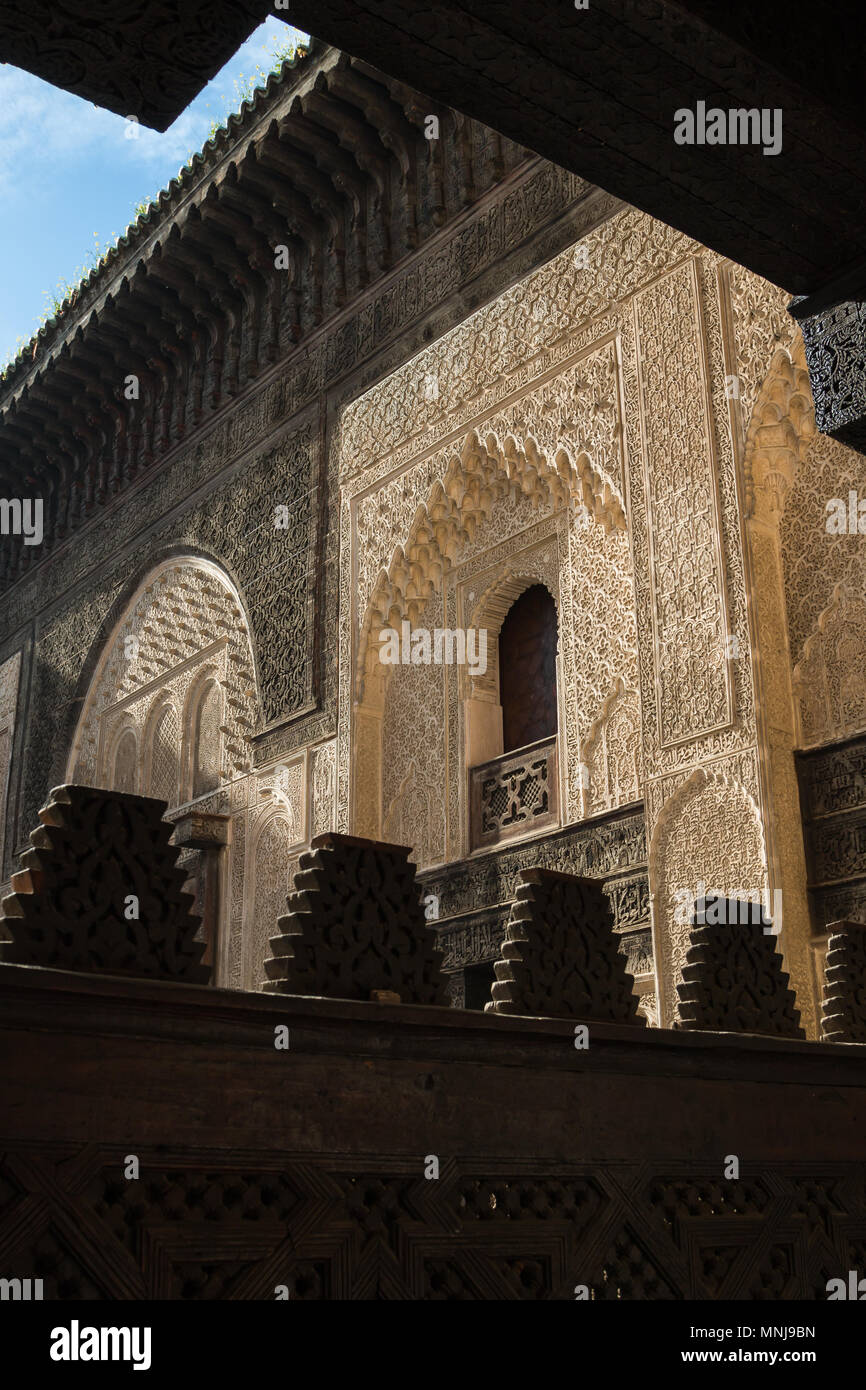 Ornate walls made of stone with traditional details. Islamic school Madrasa Bou Inania in Fez, Morocco. Stock Photo