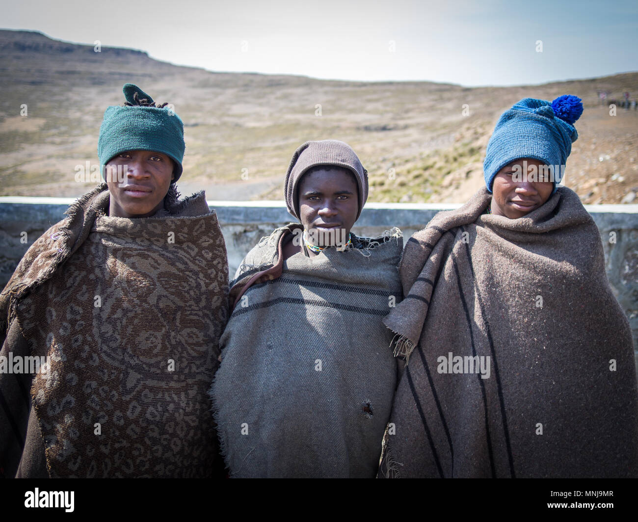 Three unidentified young African sheperds in traditional thick blankets Stock Photo