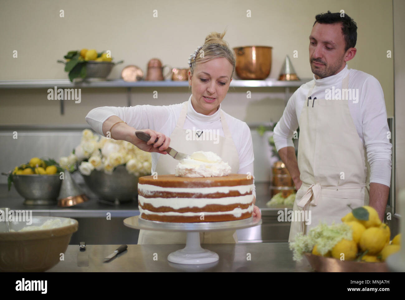 EMBARGOED TO 0001 FRIDAY MAY 18 Claire Ptak, owner of Violet Bakery in Hackney, east London, and head baker Izaak Adams put finishing touches to the cake for the wedding of Prince Harry and Meghan Markle in the kitchens at Buckingham Palace in London. Stock Photo