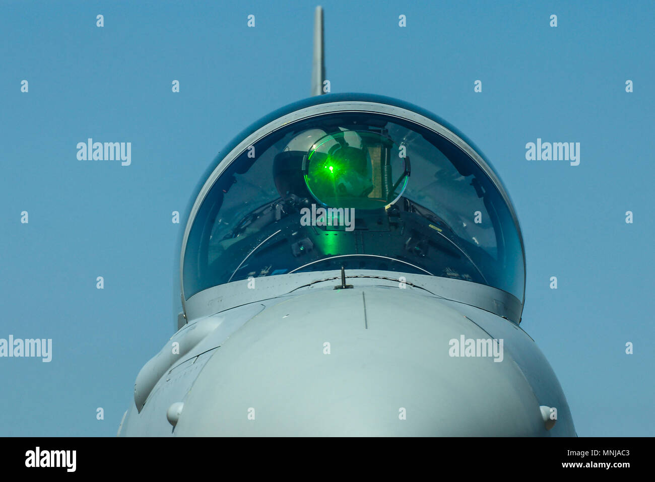 Fighter pilot. Royal Air Force RAF Eurofighter Typhoon pilot with green light effects from the head up display hud glass. Cockpit canopy. Jet plane Stock Photo