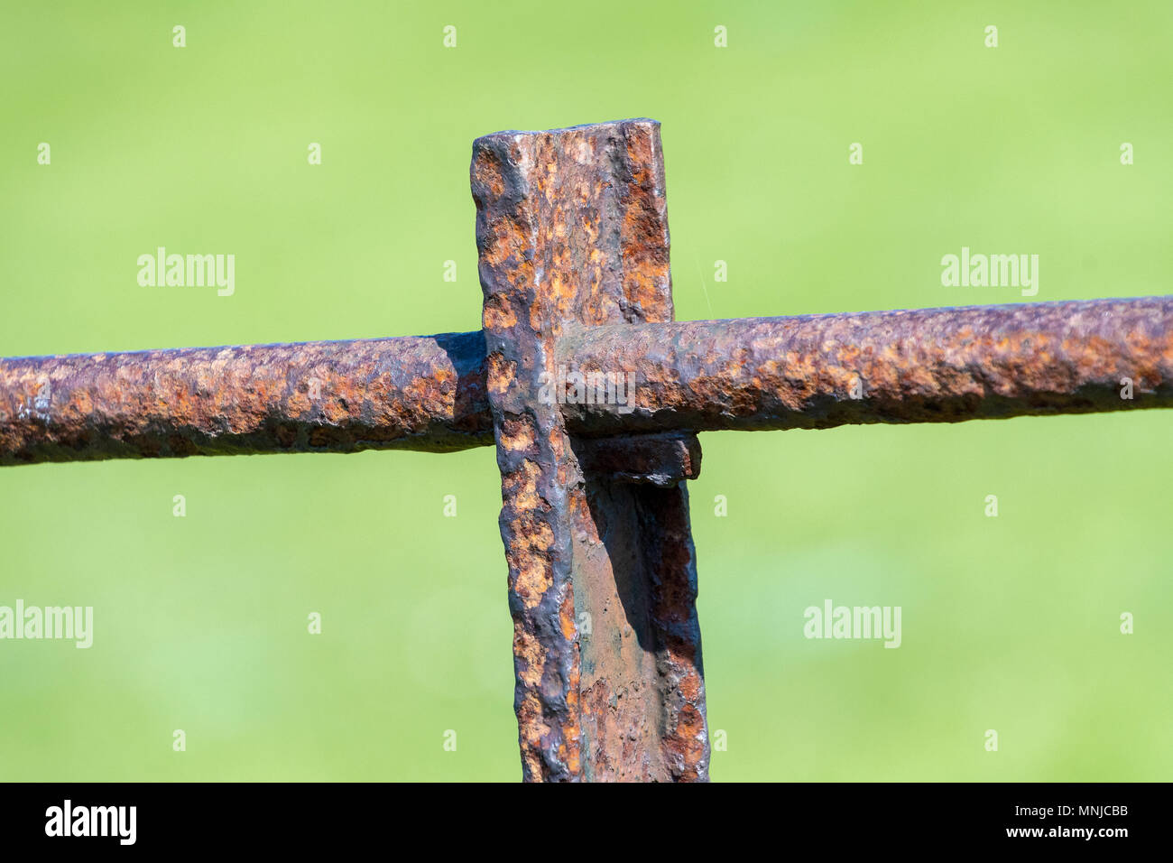 A rusty old metal section of fence in the sun Stock Photo - Alamy