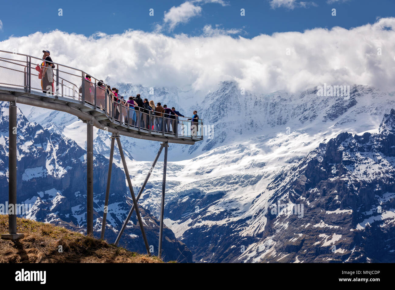 People on the observation platform at the top of First mountain above Grindelwald, Bernese Oberland, Switzerland Stock Photo