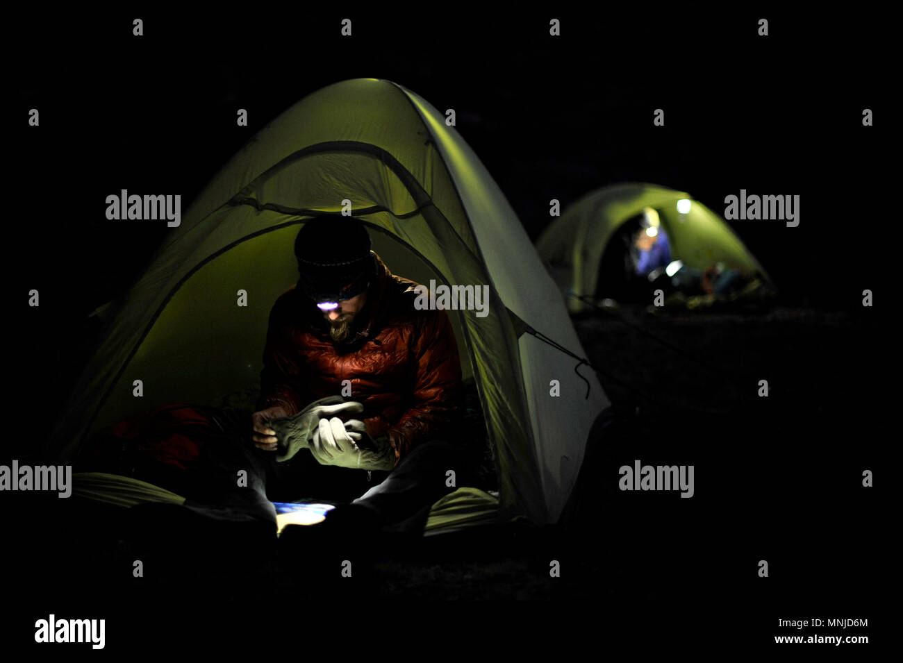 Backpackers use headlamps at night while camping near Thousand Island Lake on trek of Sierra High Route in Minarets Wilderness, Inyo National Forest, California, USA Stock Photo