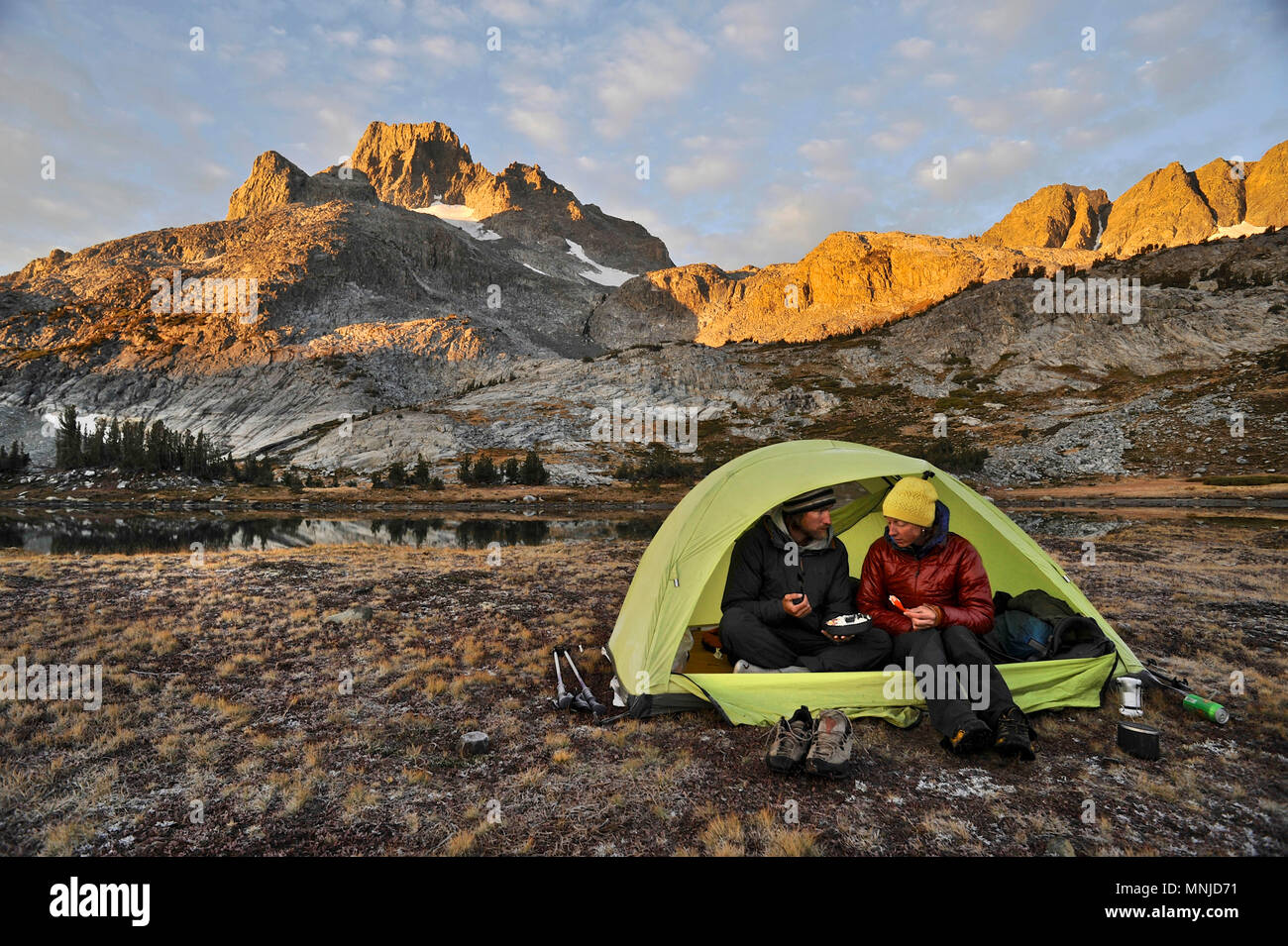 Backpackers camp near Thousand Island Lake with Banner Peak in background on trek of Sierra High Route in Minarets Wilderness, Inyo National Forest, California, USA Stock Photo