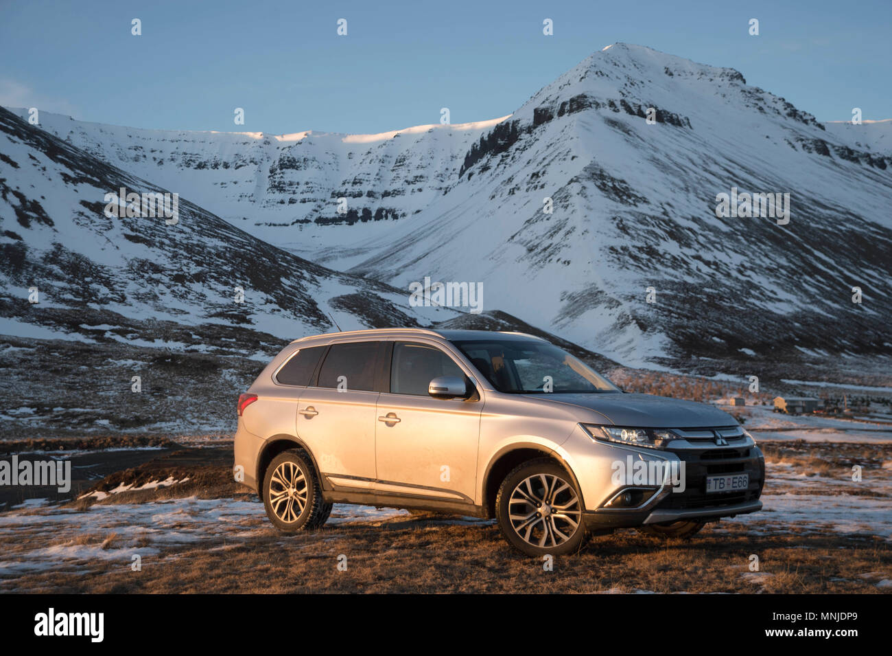 SUV in Westfjords of Iceland at sunset Stock Photo