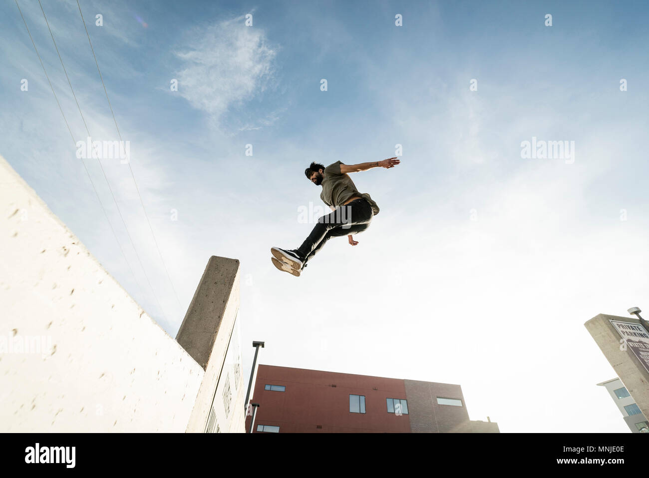 Park athlete jumping into ledge in downtown Denver, Colorado, USA Stock Photo