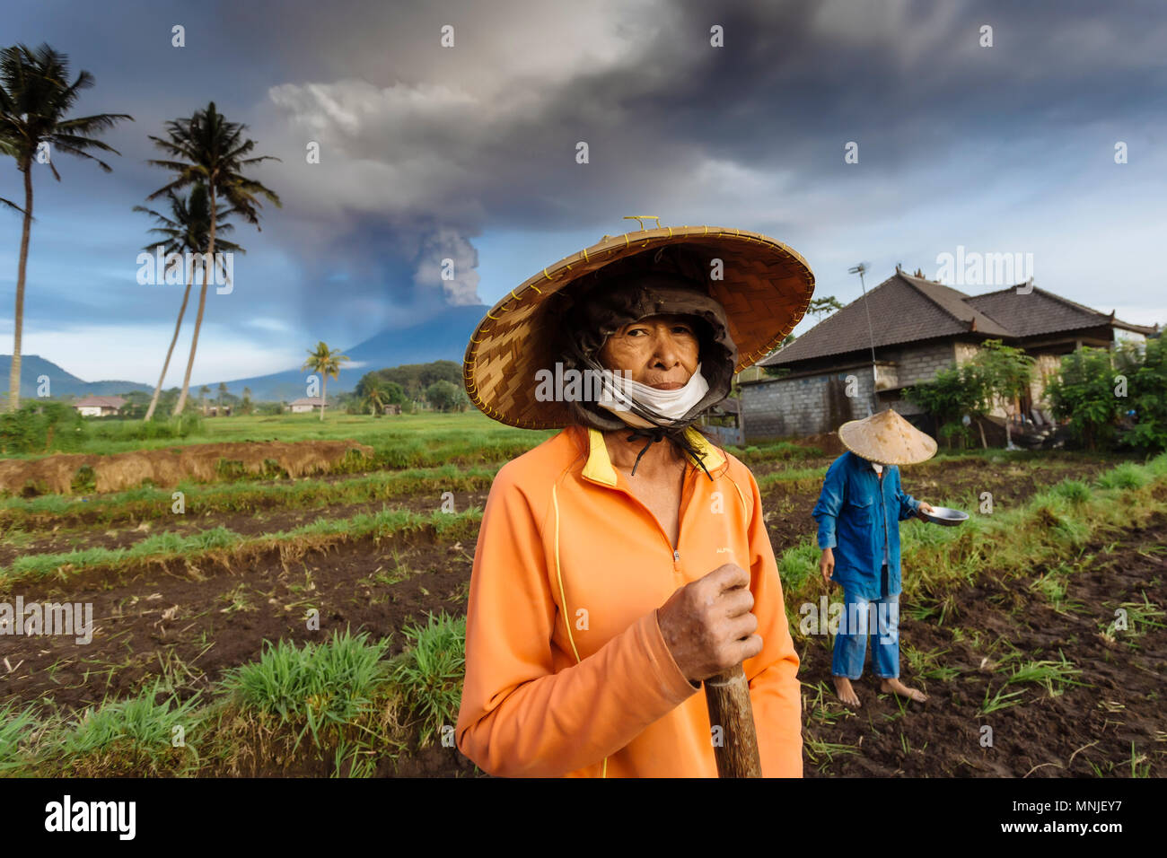 Portrait Indonesian woman with volcano Agung in background.Bali.Indonesia Stock Photo