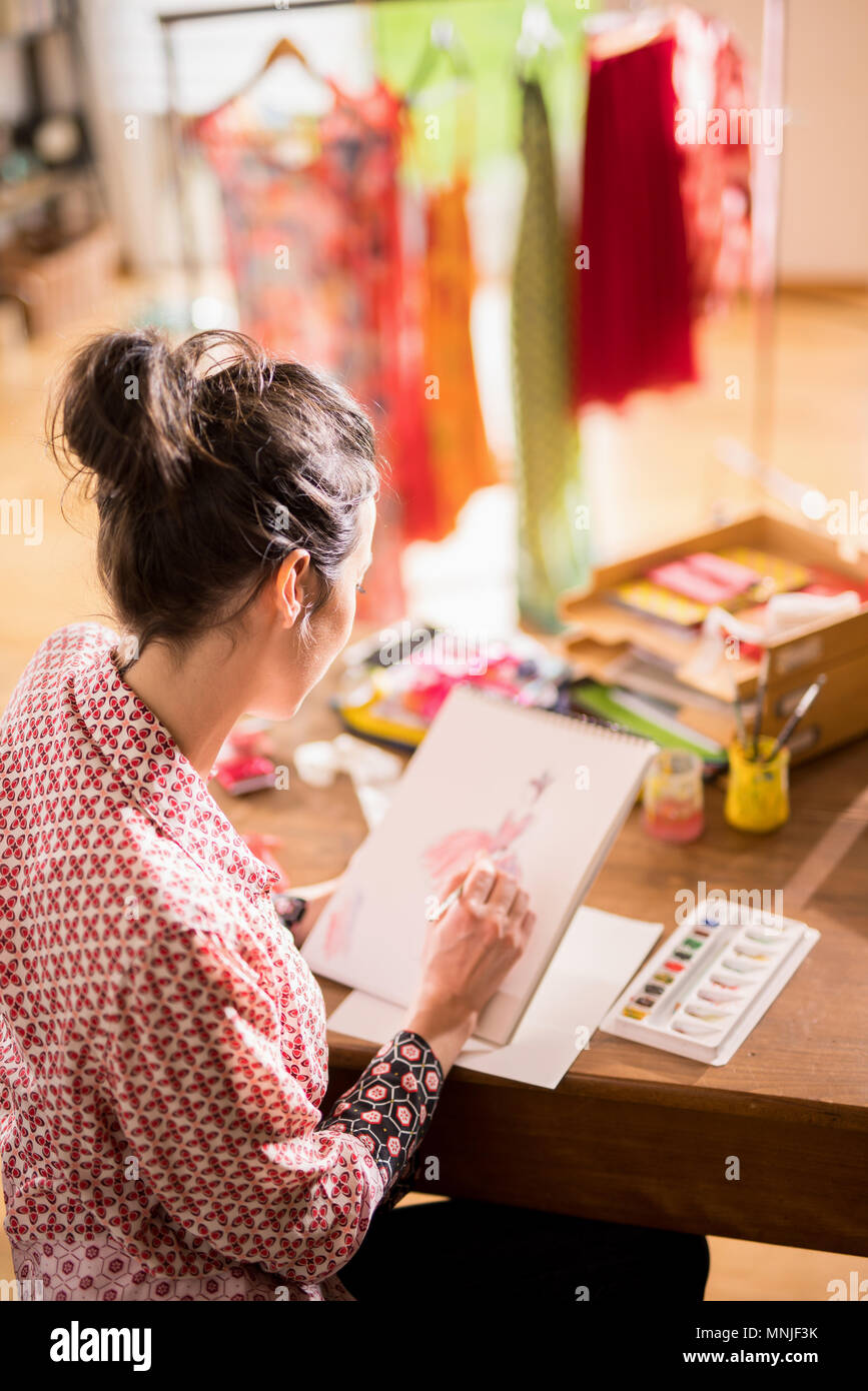 Fashion designer working on a new model, in her studio Stock Photo
