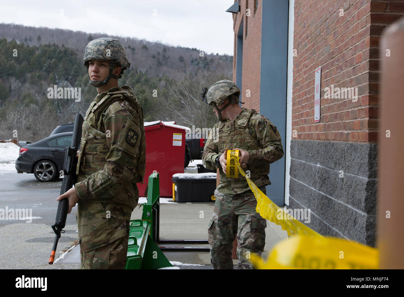 U.S. Army Cadet Bradley Thomas, left, Norwich University, provides security, while Sgt. Jay Atherton, a team leader, 172nd Law Enforcement Detachment, Garrison Support Command, Vermont National Guard, cordons off the area during a simulated active shooter scenario at the Vermont National Guard Readiness and Regional Technology Center in Northfield, Vt., March 3, 2018. The 172nd LED completed a culminating exercise that used several scenarios to address their new focus on law enforcement since reorganizing from a combative role. Stock Photo