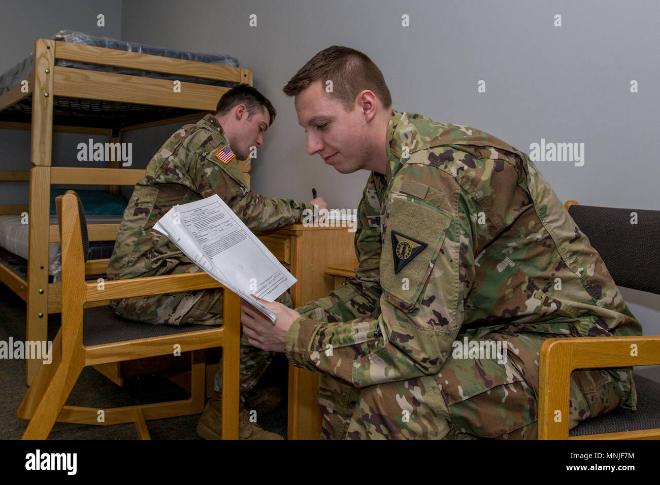 U.S. Army Sgt. Jay Atherton, left, a team leader, 172nd Law Enforcement Detachment, Garrison Support Command, Vermont National Guard, interviews Spc. Jaimee Boivin, who is acting as a witness, during a simulated investigation scenario at the Vermont National Guard Readiness and Regional Technology Center in Northfield, Vt., March 3, 2018. The 172nd LED completed a culminating exercise that used several scenarios to address their new focus on law enforcement since reorganizing from a combative role. Stock Photo