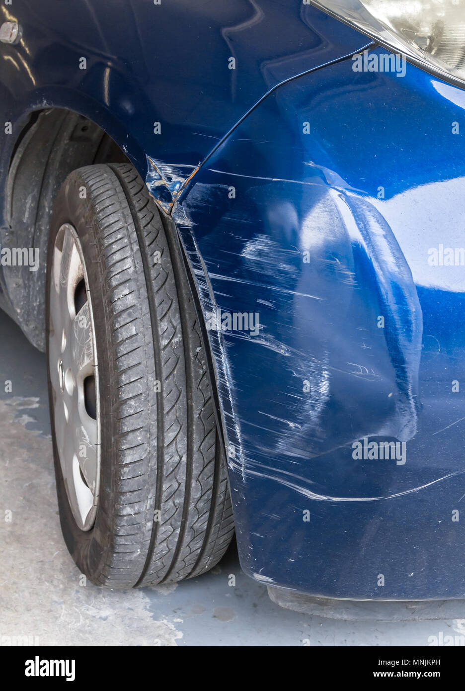 Blue scratched car with damaged paint in crash accident or parking lot Stock Photo