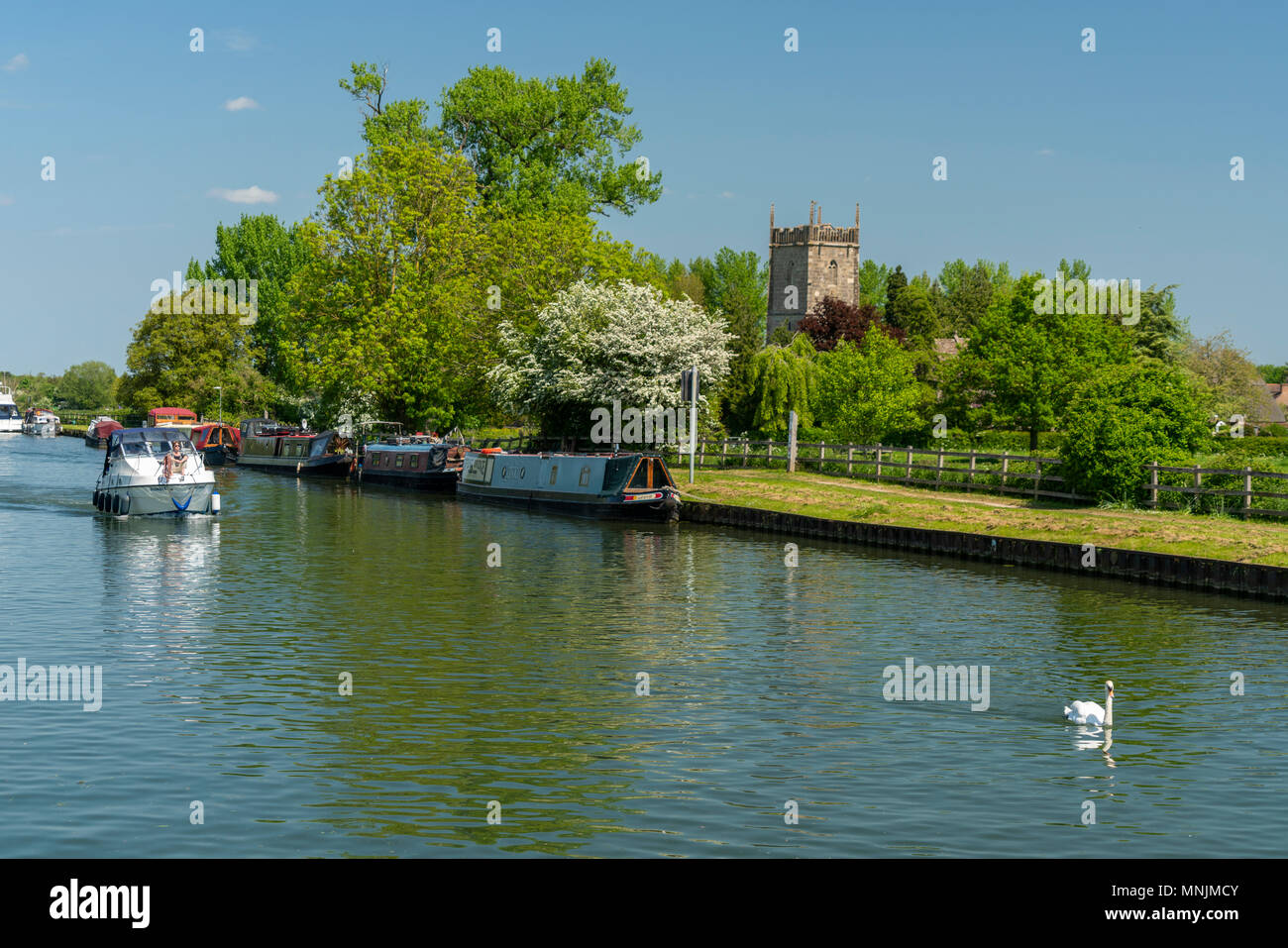 View of the Sharpness - Gloucester canal with St Mary the Virgin Church in the background, Frampton on Severn, Gloucestershire, UK Stock Photo