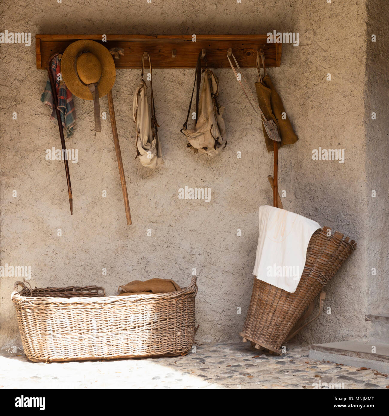 Front view of a retro style outdoor wardrobe with walking sticks, backpacks, baskets and travel equipment. Stock Photo