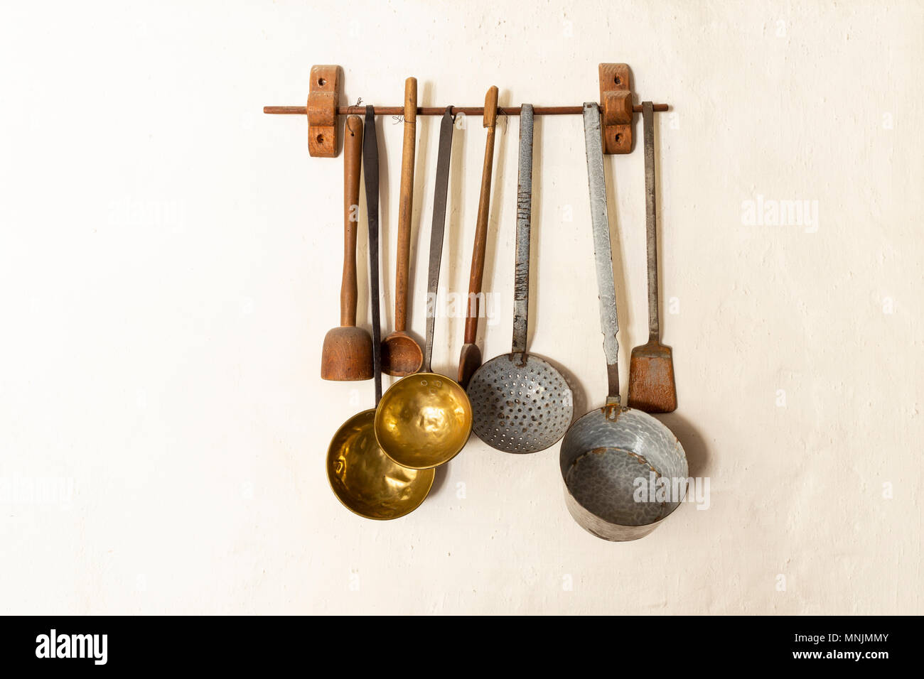 Metal Set Tools Kitchen retro style set of different wooden and metal kitchen spoons and tools hanging on a wall