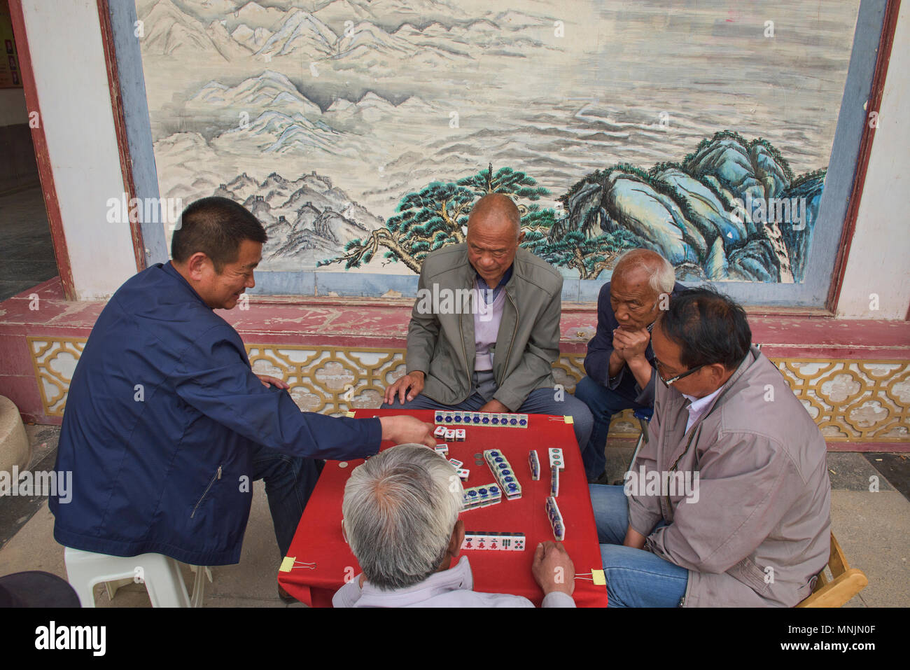 Senior citizens playing mahjong (Chinese dominoes), Zhangye, Gansu, China Stock Photo