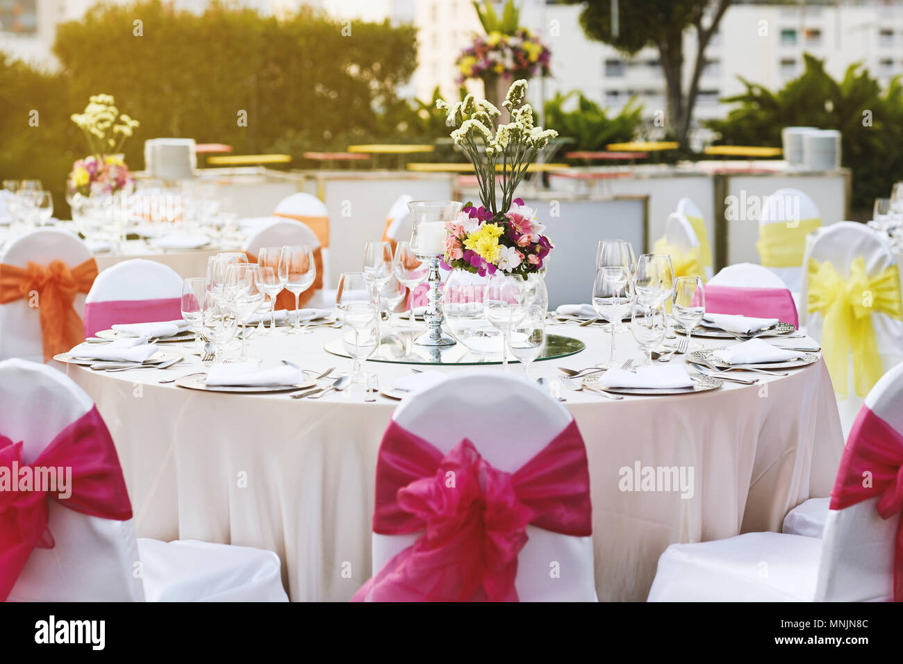Warm Sunset Light With Wedding Reception Dinner Table Setting With