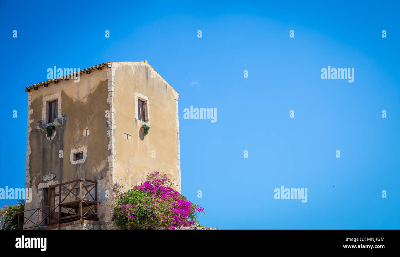 Traditional old Sicilian house during a sunny day with a wonderful blue sky background. Stock Photo