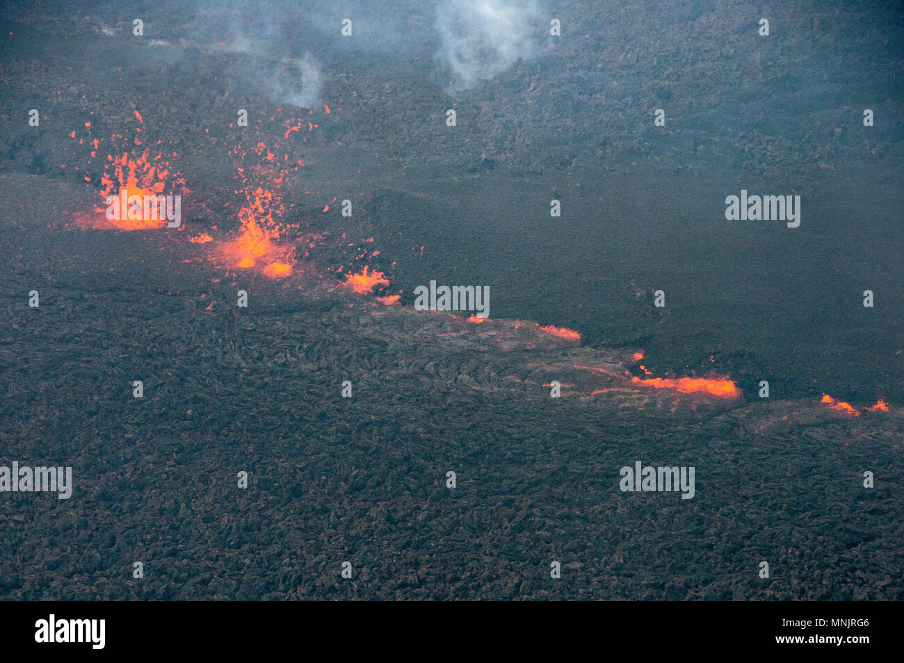 Lava and poison gases bubble out from a fissure caused by the eruption of the Kilauea volcano at