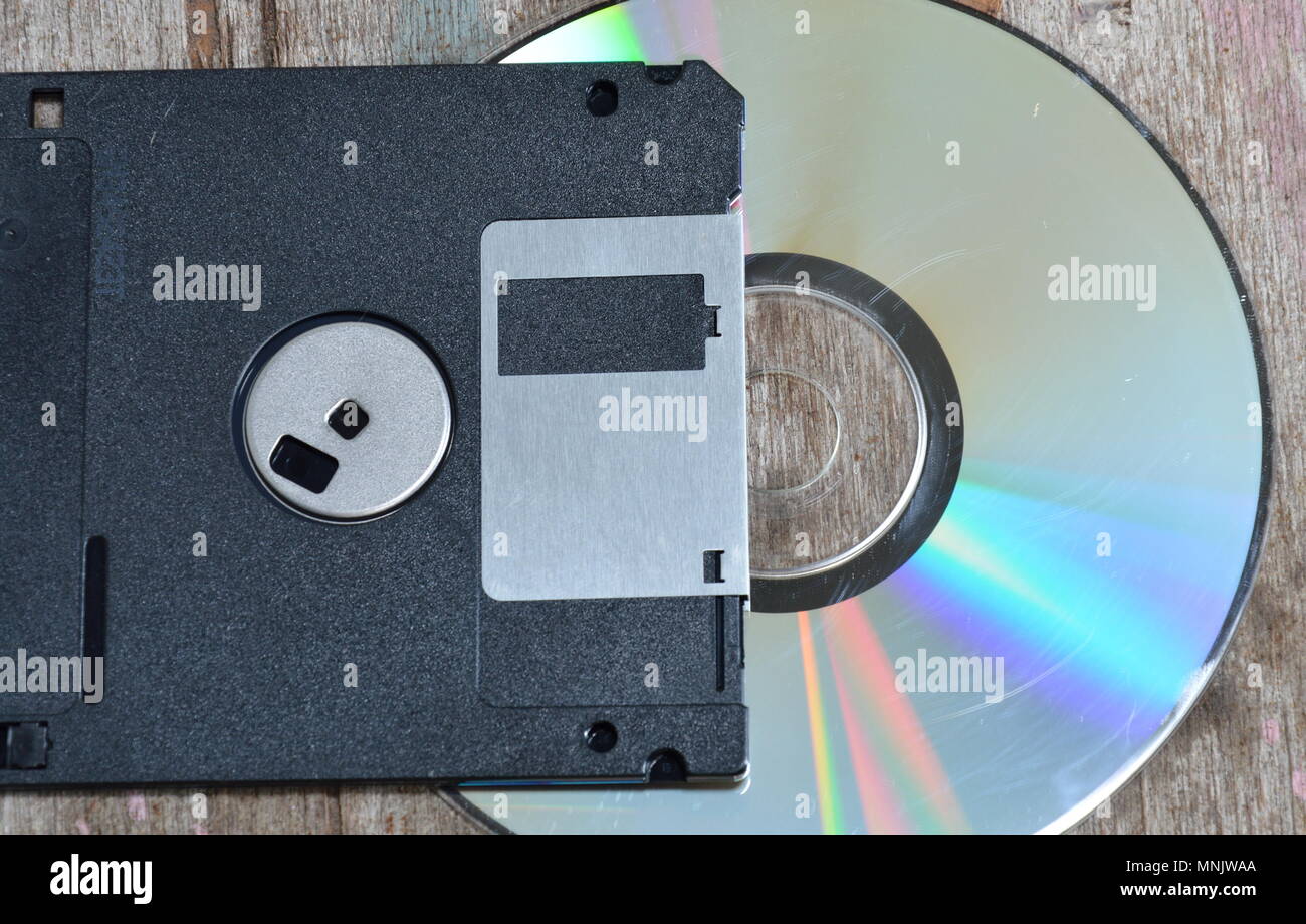 diskette and compact disc on wood board Stock Photo